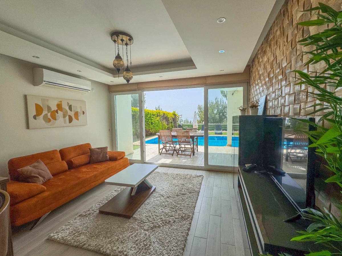 Open-plan living room and kitchen with stone wall lounge area