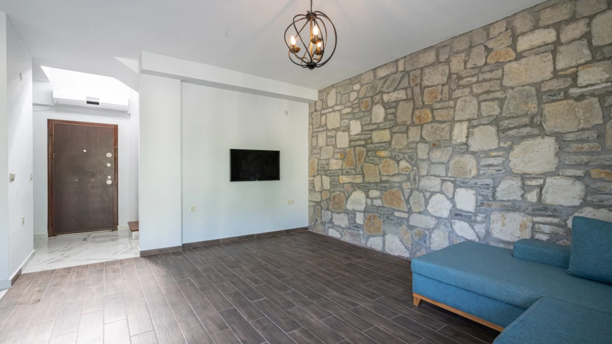 Spacious living room with stone wall detail