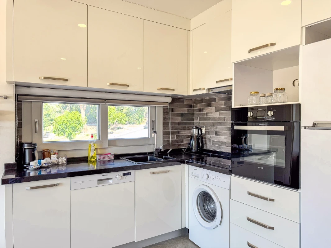 Kuşadası Lavender Residence A5 modern kitchen with built-in appliances and washing machine