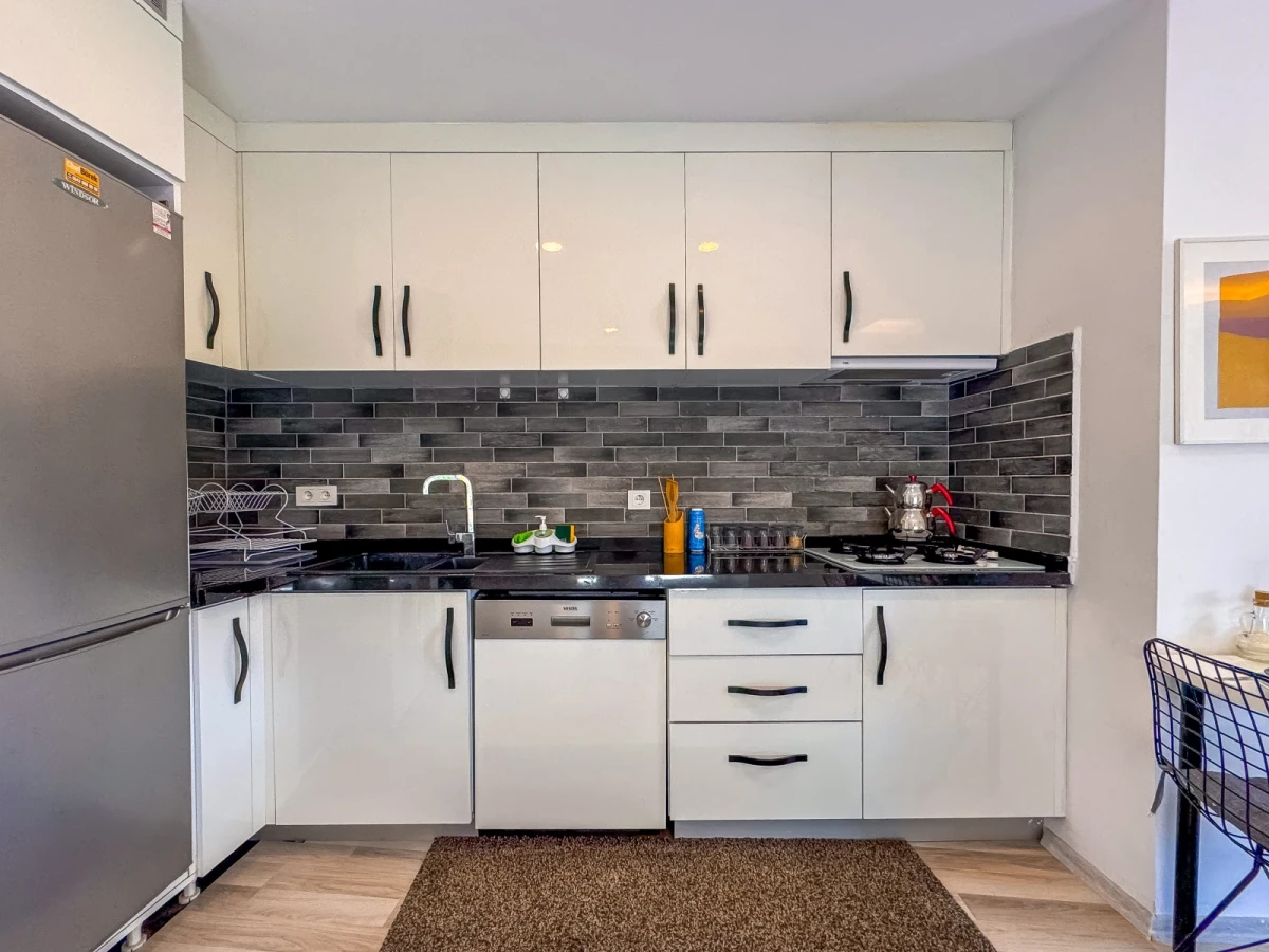 Kuşadası Lavender Residence A6 modern kitchen with cabinets and countertop