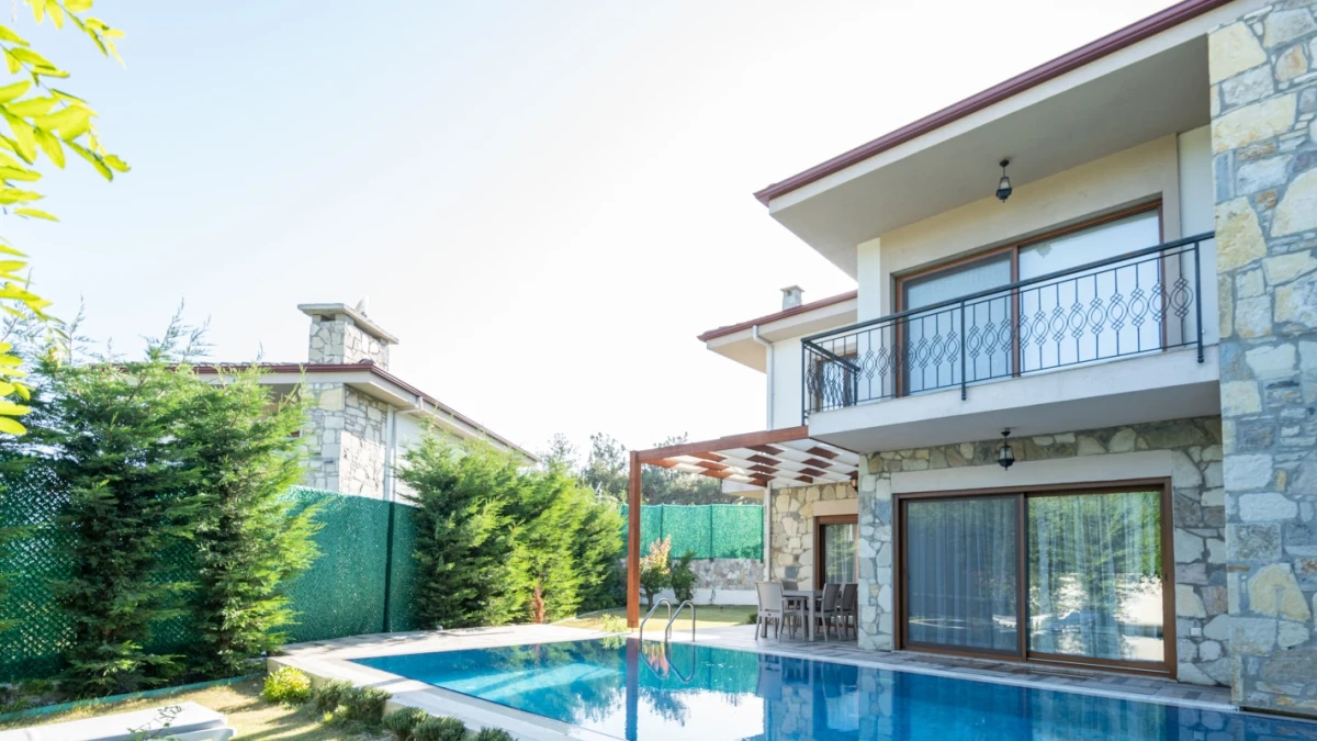 Front view of modern villa with pool and balcony