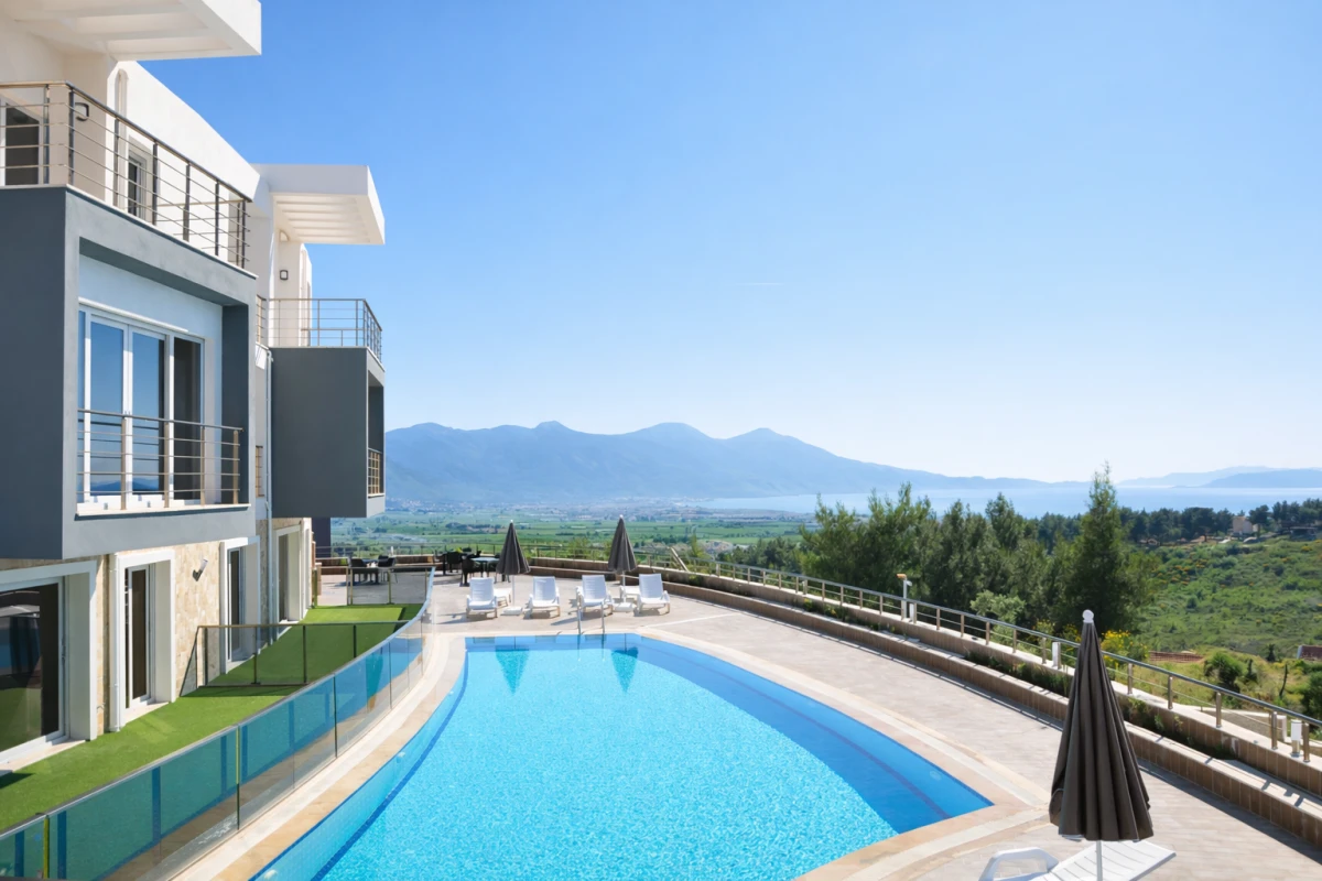 Exterior view of a penthouse apartment for sale in a complex in Kusadasi Sogucak with partial sea view